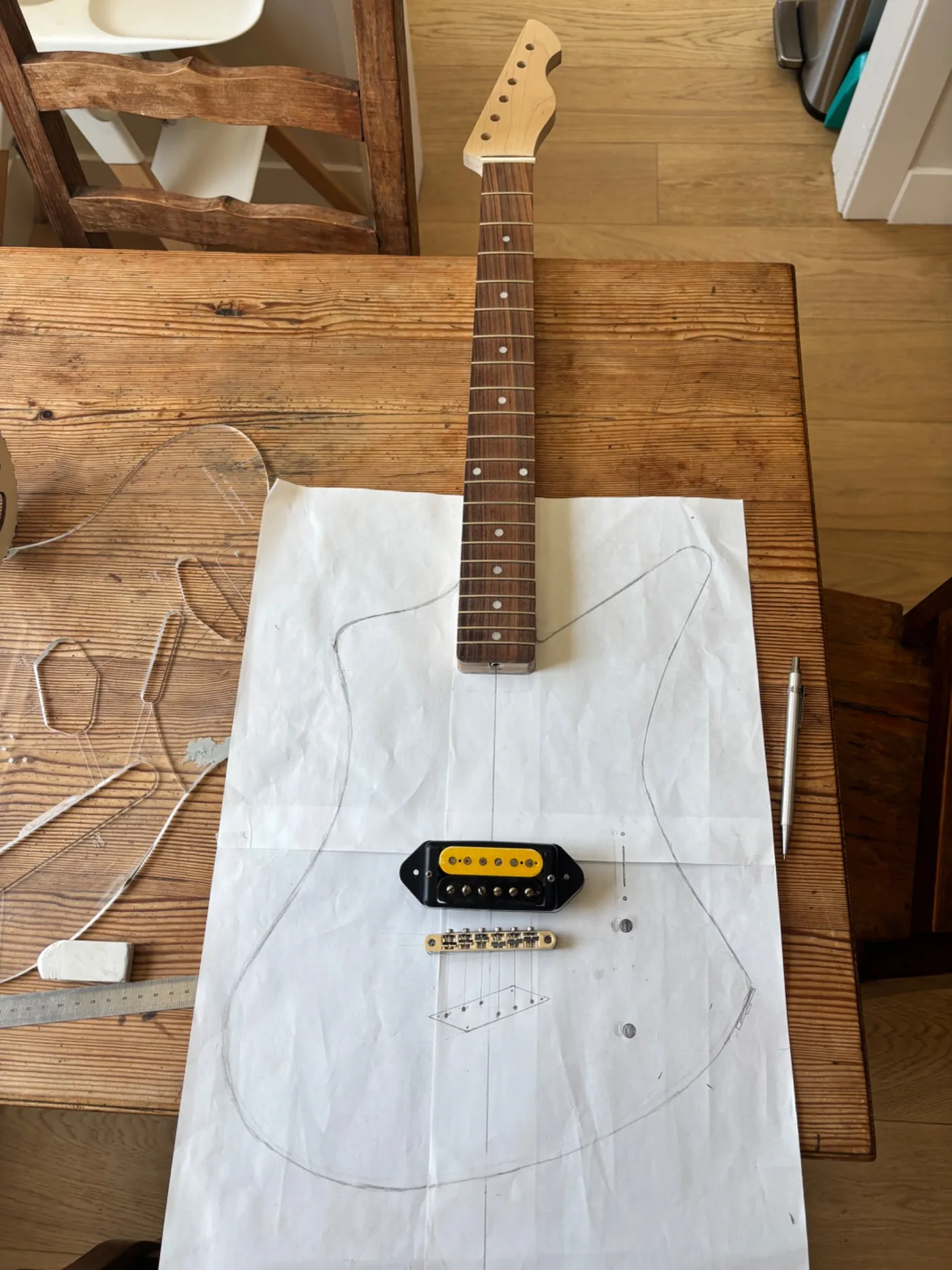 Matti Craters layout on the workbench with neck, pickup, bridge, and body drawing.
