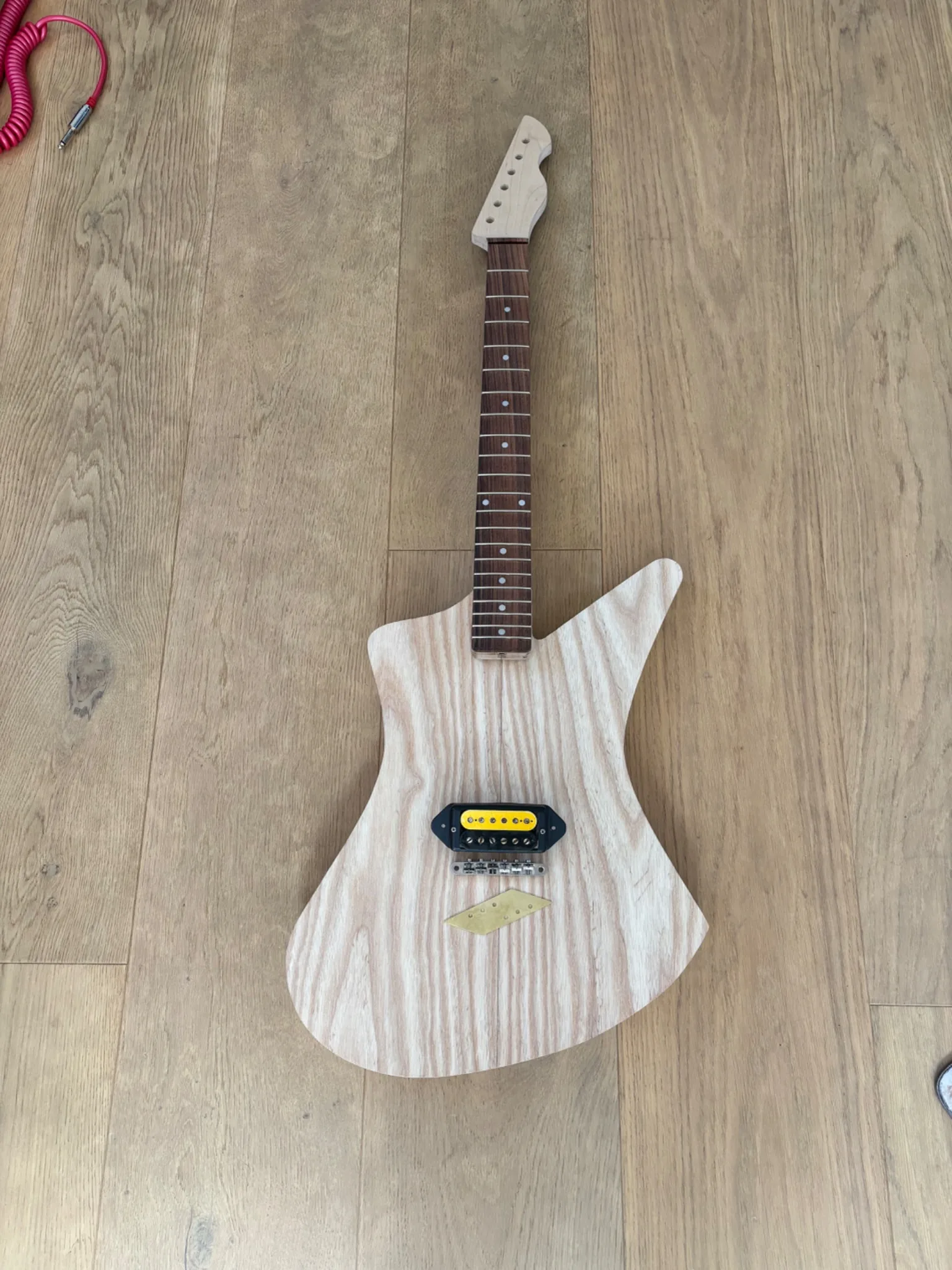 Matti Craters in-progress build with neck, pickup, bridge, and brass bridge plate layout.